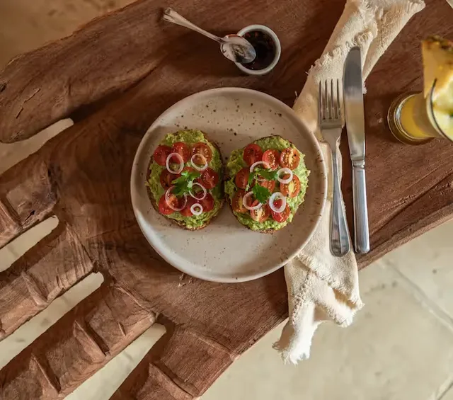 Avocado toasts served for breakfast on a carved wooden board at La Valise San Miguel de Allende